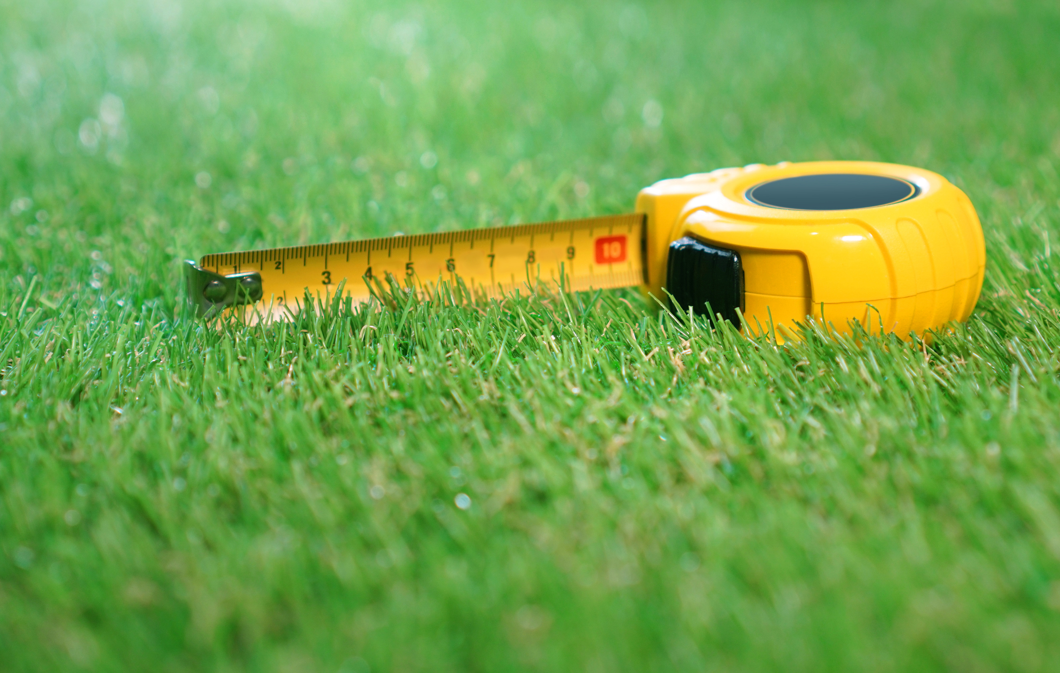 Artificial turf with a yellow tape measure